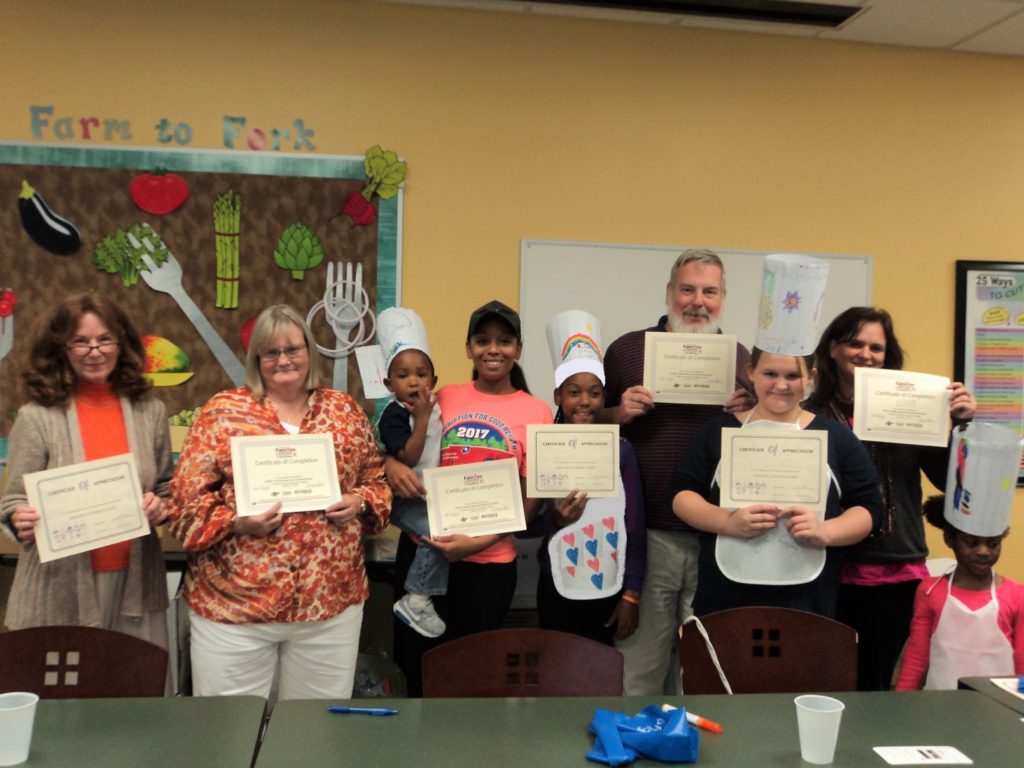 EFNEP participants holding their certificates of completion